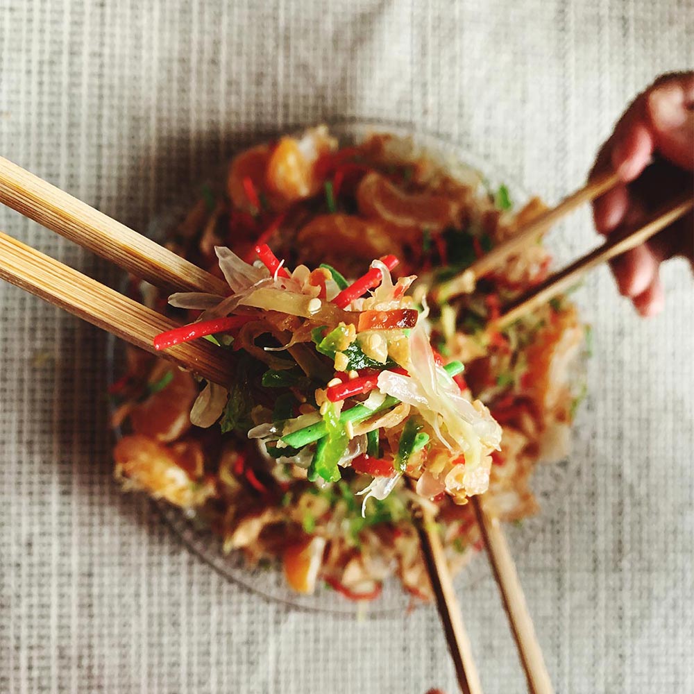 close-up-person-holding-asian-food-square